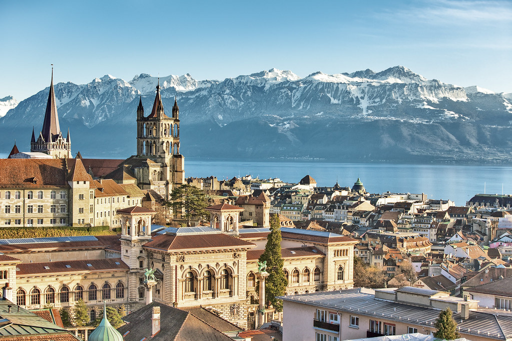 View over Lausanne with cathedral, Lake Léman and the mountains covered with snow